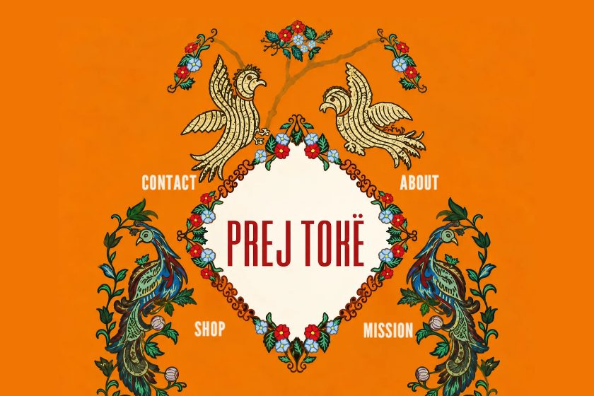 Prej Tokë homepage: an illustrated emblem with the menu set around it